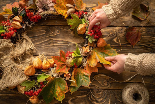 Making a Christmas wreath out of natural, autumn materials. 