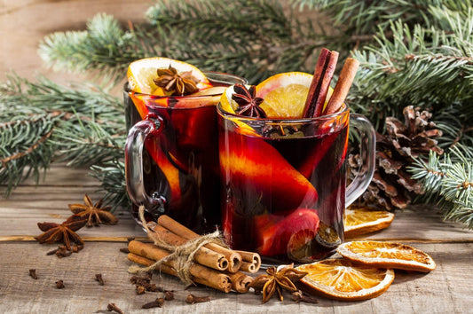 christmas hot mulled wine with cinnamon cardamom and anise on wooden background